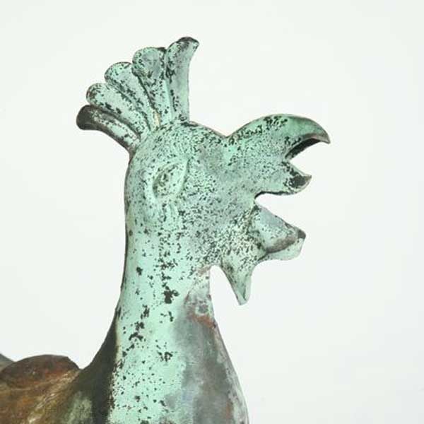 Molded crowing rooster with raised and articulated tail, on a stand.<br />
<br />
Folk art rooster weathervanes have been popular since the earliest weathervanes were made in the 19th century, and the term “weathercock” is synonymous with the term