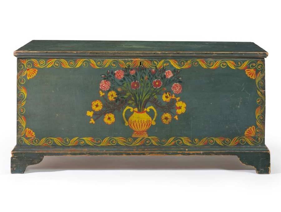 This remarkable blue painted and polychrome freehand-decorated chest sports an elaborate vase of flowers, dominated by the cabbage rose, bordered by scroll decoration with fan corners, all indicative of the Schoharie Valley of New York.<br />
<br