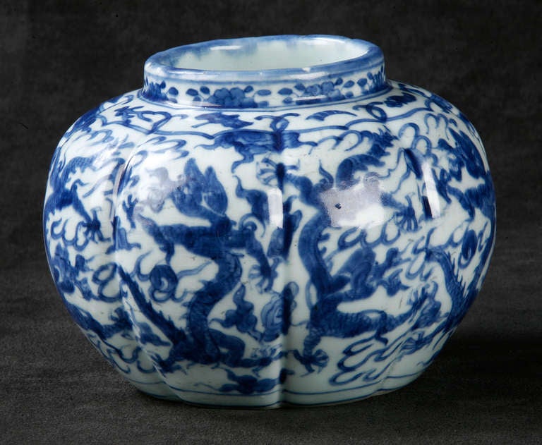 Spheroid-Shaped Eight Lobed Jar Showing Dancing Dragons Filling Each Lobe.  The Dragons Alternate Standing Upright or Facing Down  amiid Flames and Chasing the Flaming Pearl.  
Emperor Wan Li (1573ADE-1619ADE) Mark in Underglaze Blue on the Base