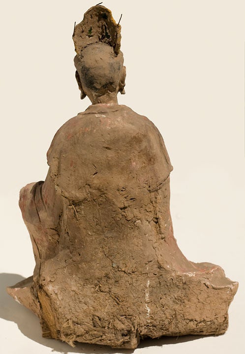 The Figure Seated in a Position of Royal Ease (Lalitasana) with Both Hands in an Earth-Touching Position (Bhumisparsha Mudra).  The Robe and Base are Covered in a Russet Cold Paint, the Body Covered in white Gesso, with Other Areas Showing Touches