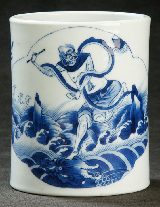 Rare and Fine Chinese Blue and White Brushpot (Ch. Bitong), Exquisitely Painted in Rich Cobalt Blue, in the Main Cartouche, Depicting the Daoist Deity Kaishing Leaping over  Roiling Waters, Subduing a Mythical Beast.  The remainder of the body