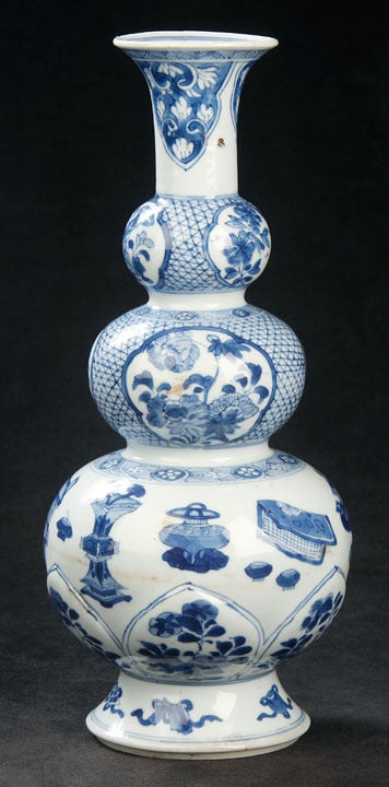 Decorated in Various Shades of Cobalt Blue, the Triple Gourd Vase Displays Floral Cartouches on the Top two Gourds and the 100 Antiques Motif on the Bottom Gourd.