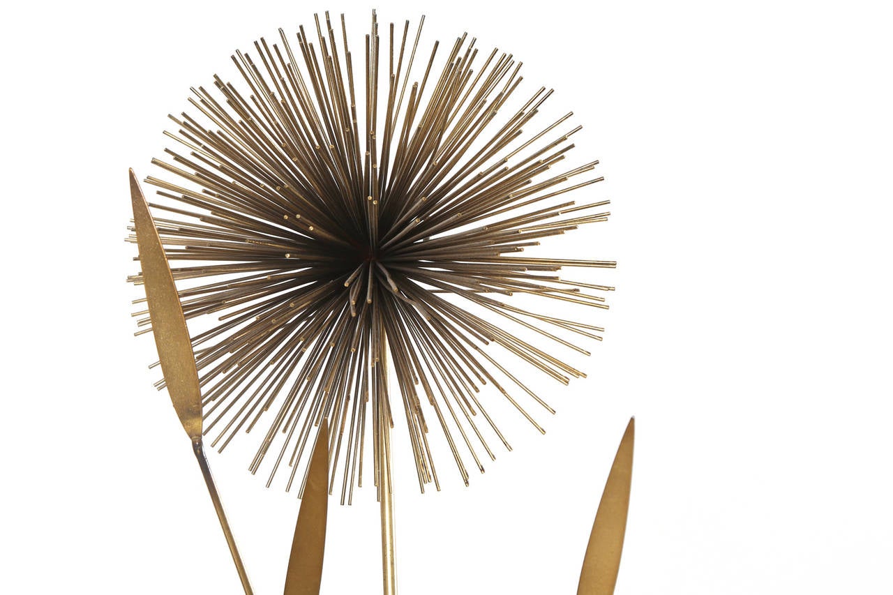 Curtis Jere brass wall sculpture from 1979. This stunning all original examples has patinated brass pom poms or dandelions with leaf accents. Looks great horizontally or vertically.