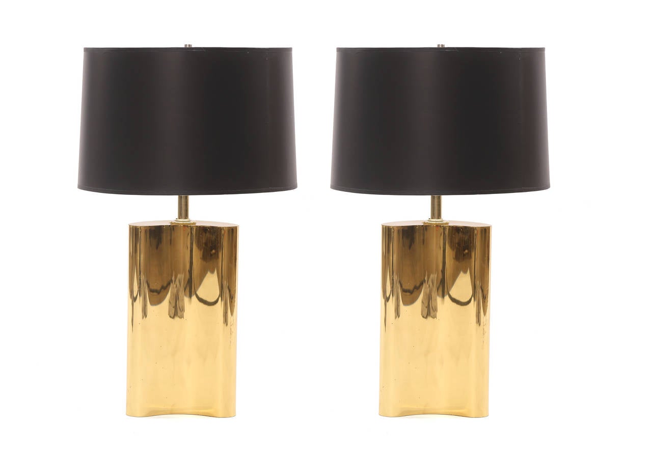 Pair of free-form polished brass lamps, circa mid-1970s. These examples have curvaceous forms and look great with white or black shades. Price listed is for the pair without shades. Height to top of current shades is 27.5
