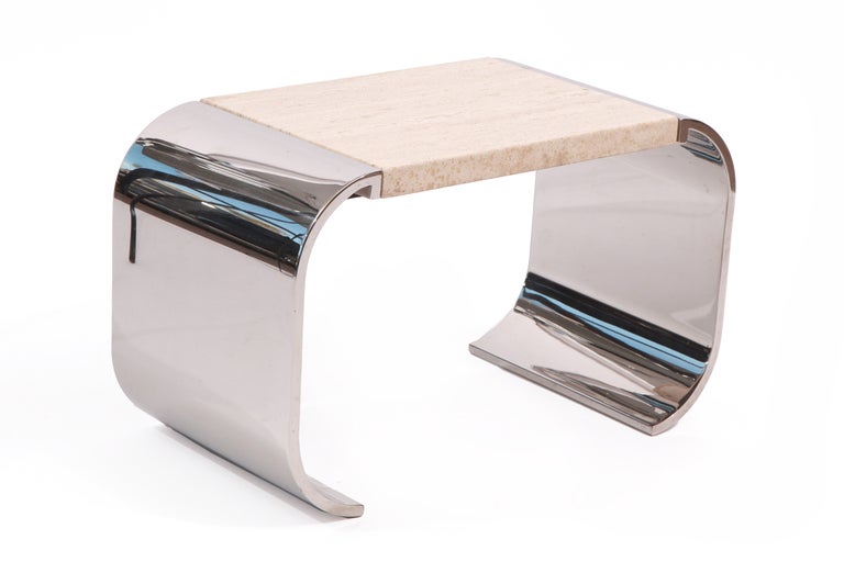 Stainless steel and travertine occasional table circa early 1980's. This example has an undulating sculptural form with an inset 1
