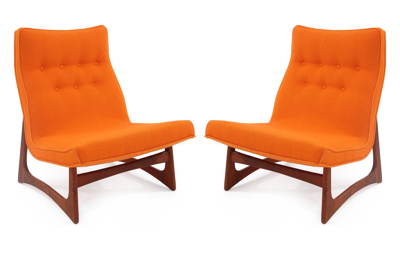 Stunning pair of large-scale lounge chairs by Adrian Pearsall, circa early 1960s. These sculptural examples have beautifully grained solid walnut bases and stretchers and have been newly upholstered in a striking orange Knoll Cato upholstery. Price