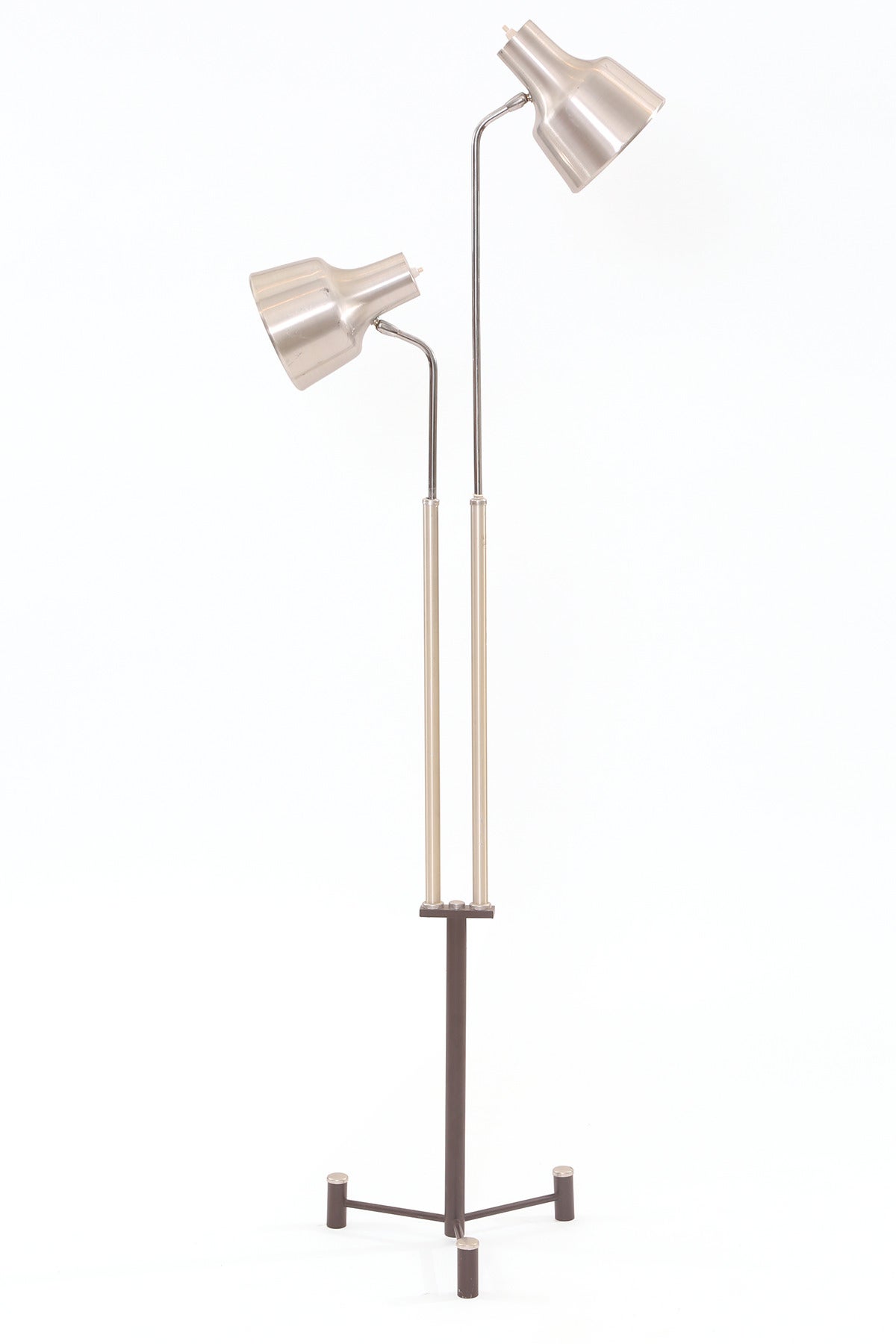 Aluminum and steel floor lamp from Denmark, circa mid-1960s. This example has pivoting satin finished aluminum cone heads. The height on each side is also adjustable. The tripod base is chocolate brown enamel and the lamp has been newly wired.
