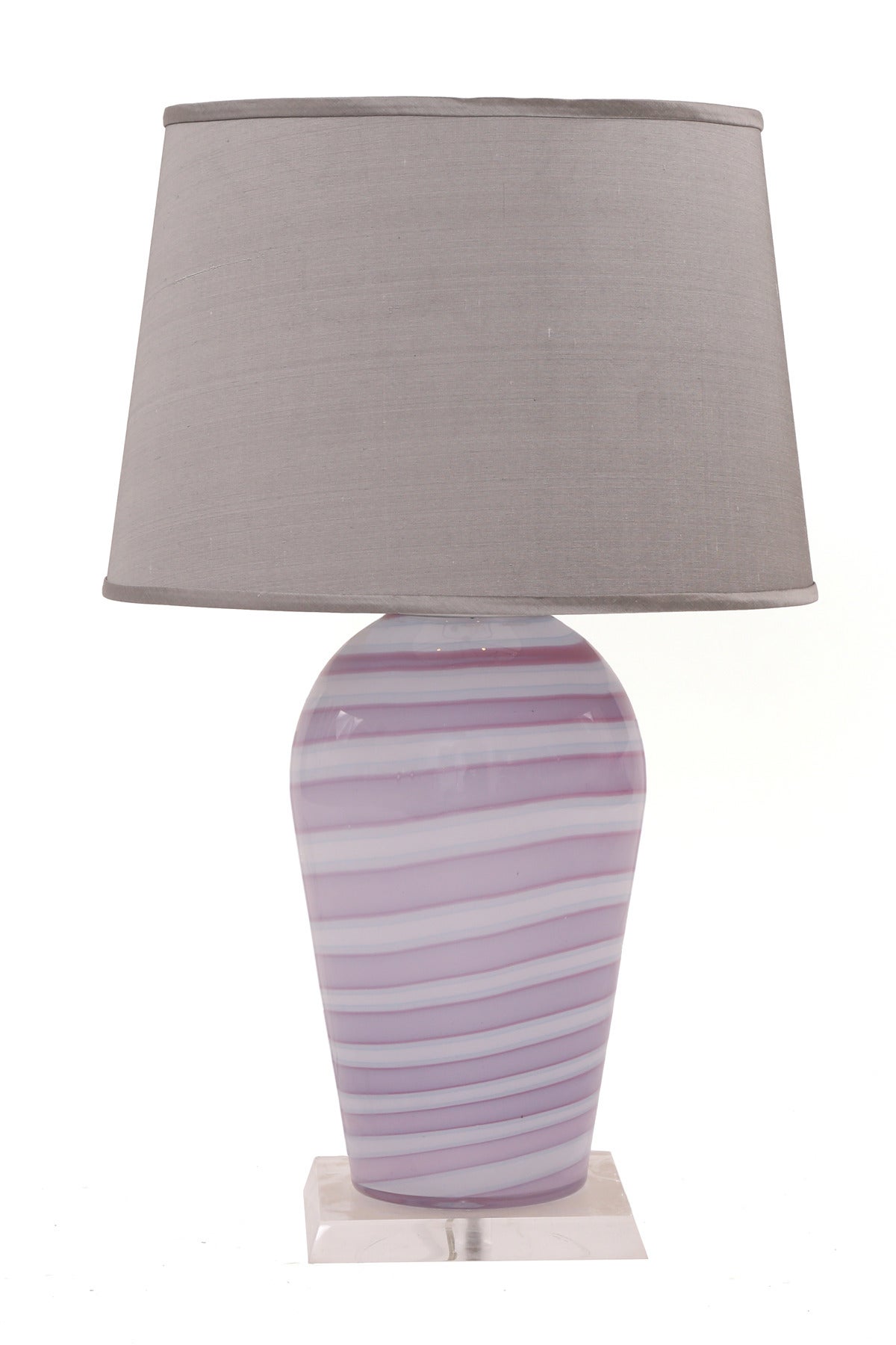 Pair of Murano glass and lucite table lamps from Italy, circa early 1970s. These unusual examples incorporate hues of purples and grays and sit atop square lucite bases. Measurement to top of socket is 19.5