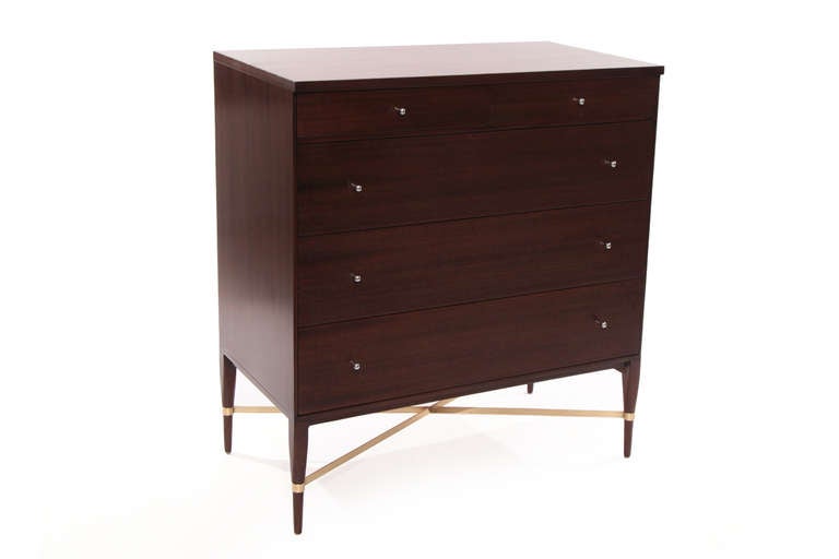 Striking Paul Mccobb for Calvin chest of drawers circa mid 1950's. This example is made of striped African mahogany and has three large drawers and two smaller drawers. The pulls have been newly plated and the x base has a hand rubbed satin finish.