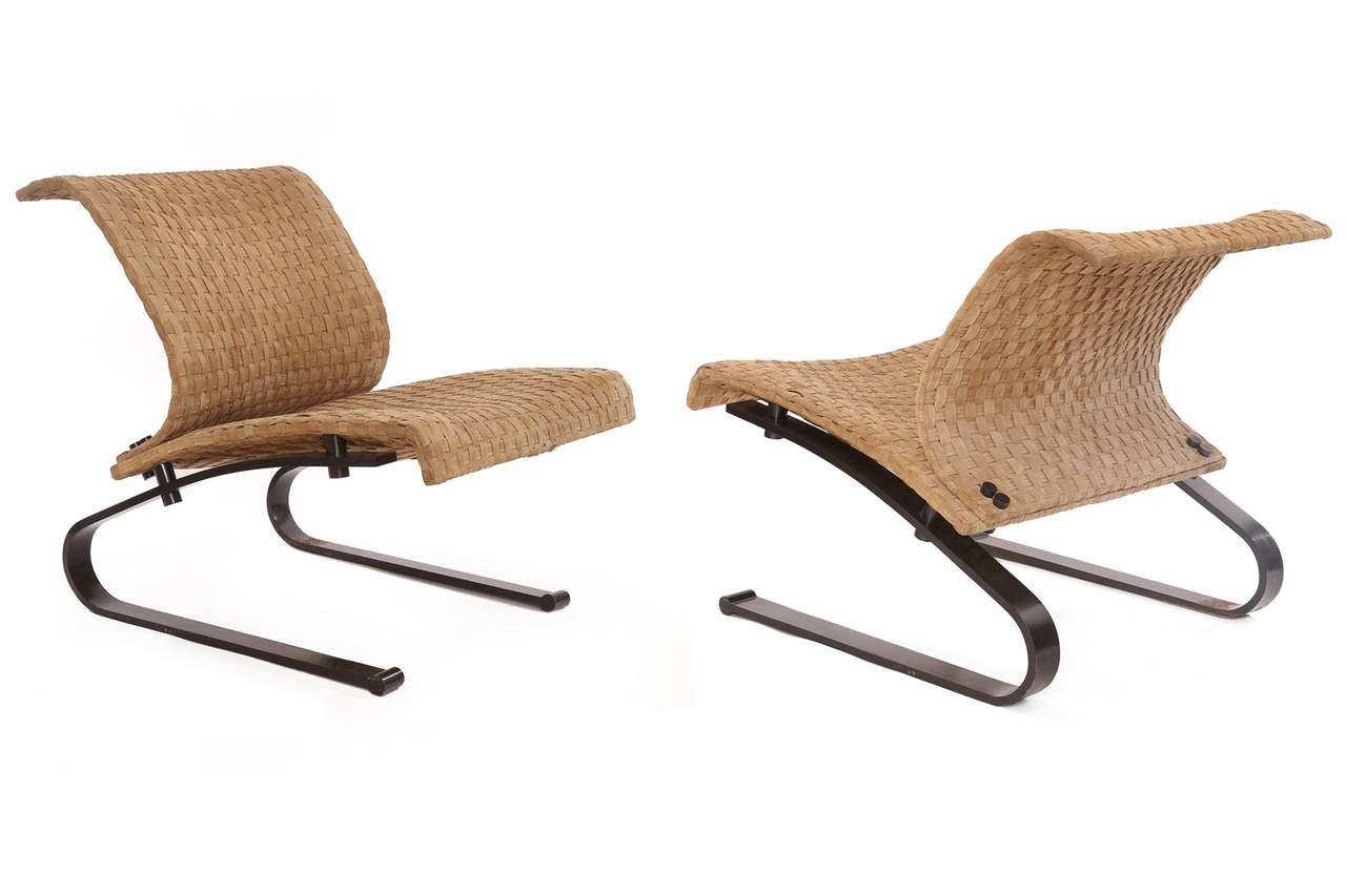 Pair of bronze finished and woven suede lounge chairs by Saporiti, circa late 1970s. These sculptural stout examples have cantilevered bronze finished steel frames with bronze accents. The upholstery is original supple woven suede. Price listed is