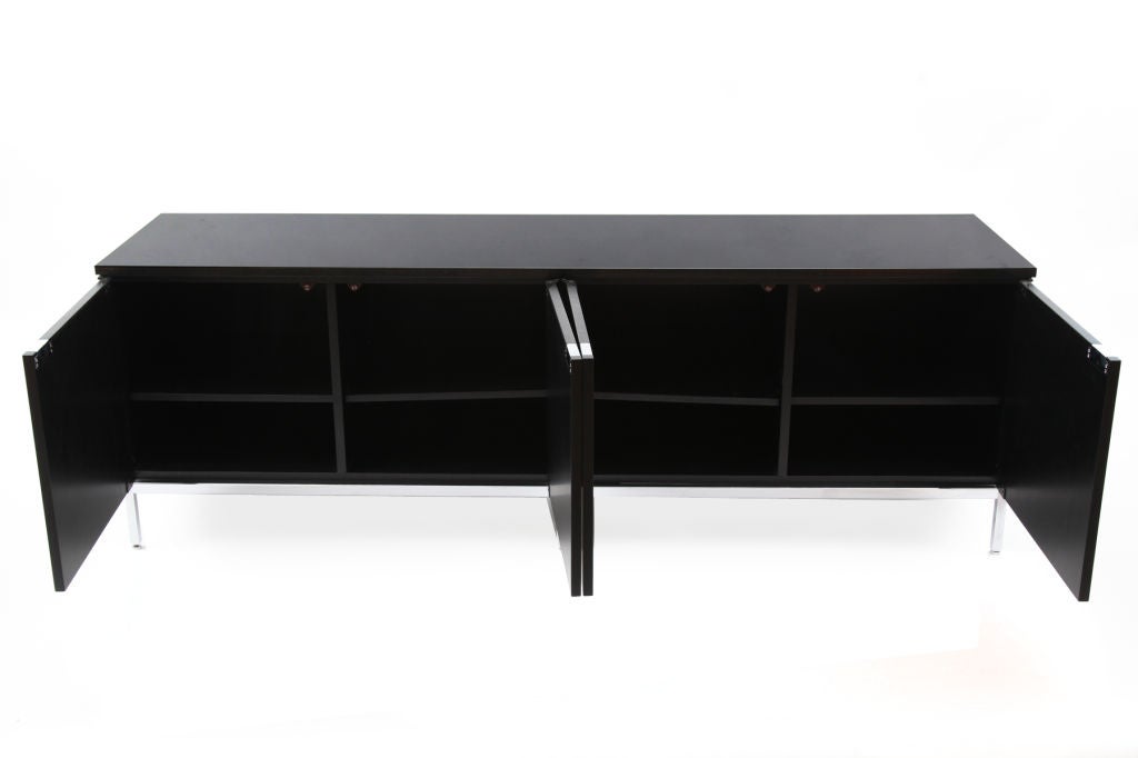 Florence Knoll for Knoll granite and oak sideboard. This black on black example has its original ebonized oak case with stunning Andes black granite top. There are four doors each with inset chrome pulls and adjustable interior shelf. Excellent