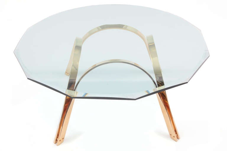 Trimark solid brass and glass cocktail table circa early 1970's. This sculptural example has a free form solid brass base and retains its original stunning bevelled glass top.