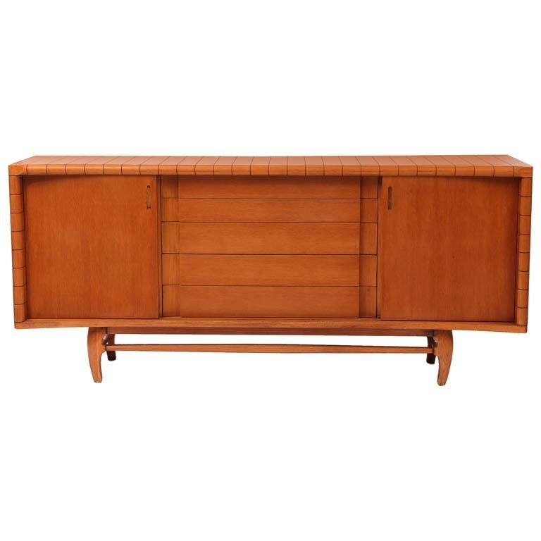Solid oak sideboard by Harold Schwartz for Romweber, circa early 1950s. This incredible all original example has a ribbed or scalloped subtly curved top and sides and sculptural formed oak legs and stretchers. There are five center drawers and two