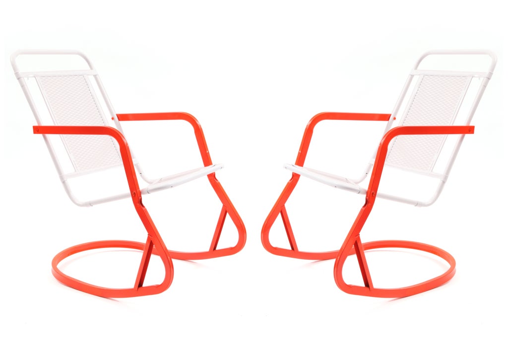 Pair of steel and aluminum rocking chairs, circa early 1960s. These examples have formed steel backs and seats and formed aluminum rockers. They have recently been powder coated in a radiant orange and snow white. Great for indoors or out. Price is