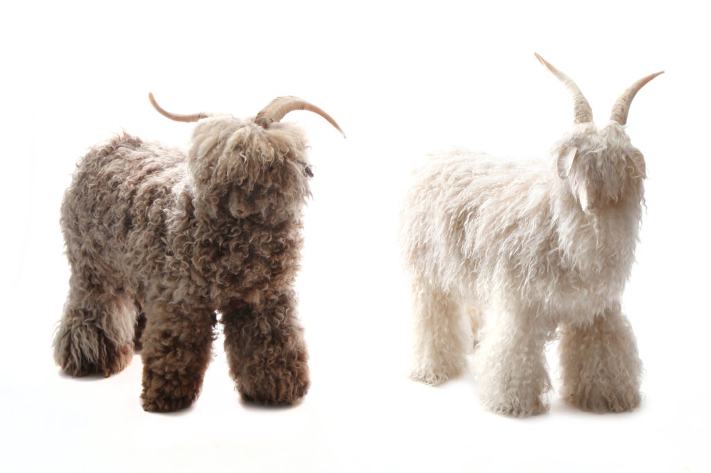 Pair of large scale horned sheep circa 1960's. These examples (one brown one off white) are clad in supple lambswool and real horns. Price is for the pair. Brown Height: 29