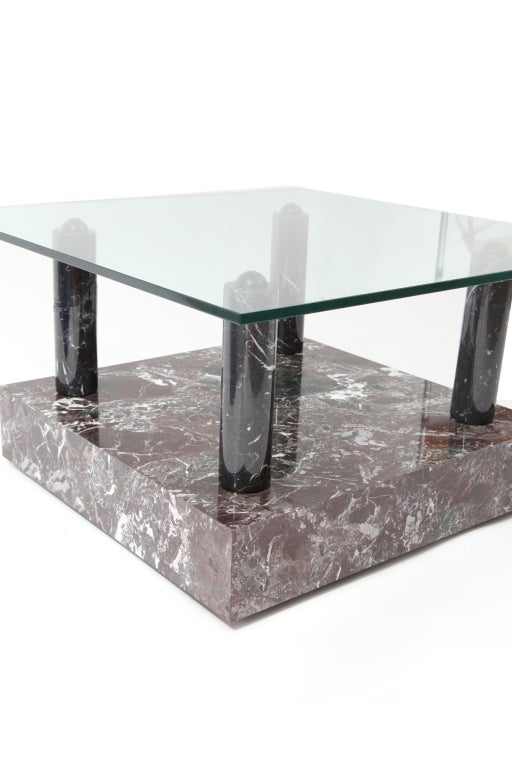 Rare Ettore Sottsass for Knoll 'Central Park' marble and glass occasional table circa 1983. This example has 4 solid Nero Marquina marble columns that sit atop a marble Emperador base that has hues of browns reds greens and whites. Base 24.25