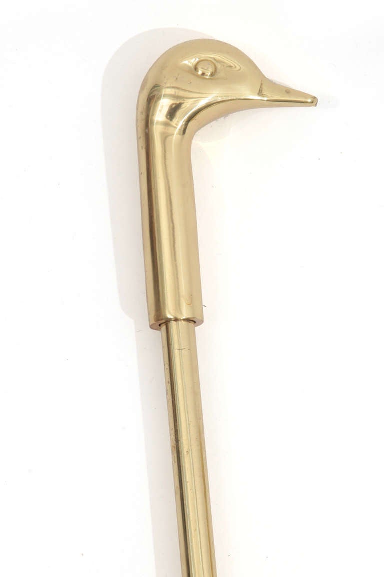 Elegant brass duck head fireplace tools circa late 1960's. Included in the set are a shovel, brush, tongs and prodding tool.