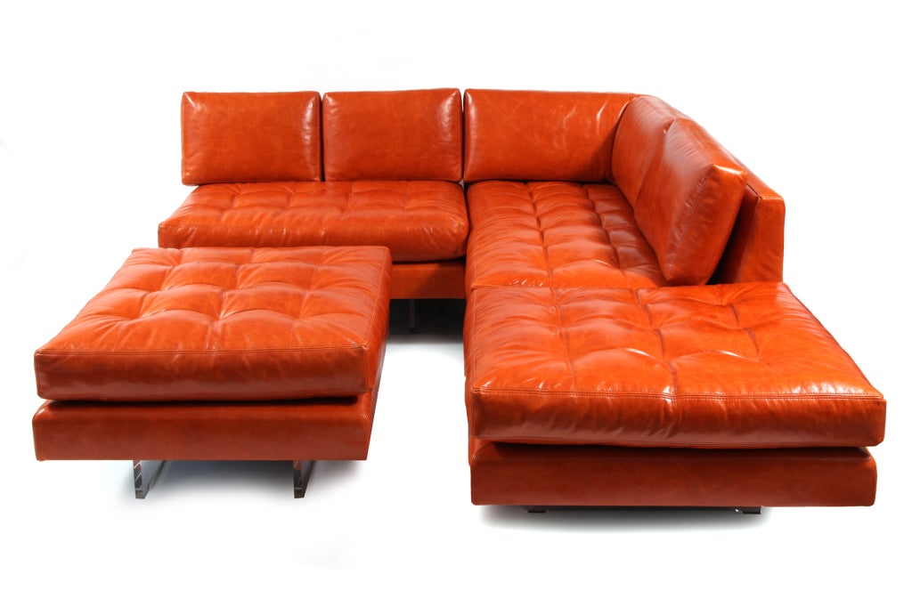 Vladimir Kagan Omnibus sectional sofa circa early 1970's. This example has a sofa, large chair  or loveseat and large scale ottoman. It has been recently upholstered in a lovely tangerine leather which pops beautifully atop the lucite bases. All of