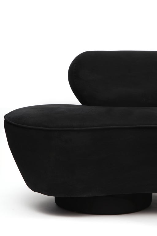 Vladimir Kagan for Directional serpentine sofa. This 8' example is upholstered in its original black ultra suede and has a lucite plinth base.