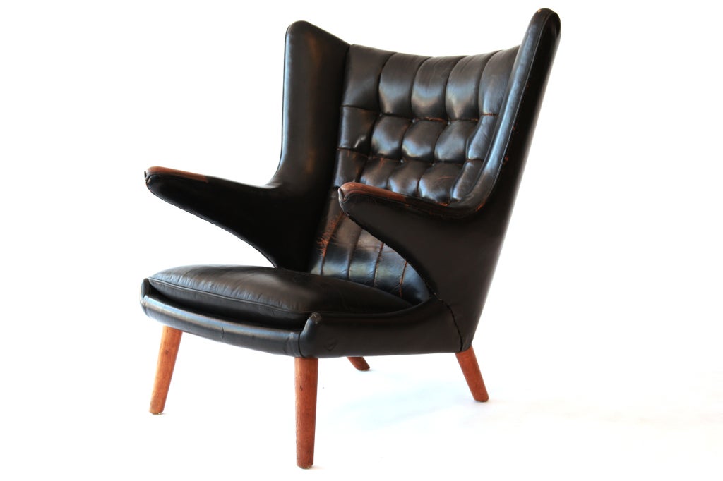 Rare original leather Hans Wegner for A.P. Stolen Papa Bear chair circa early 1950's. This example has the early A.P. Stolen label and wonderfully patinated black leather. Oak arms and legs are also all original.