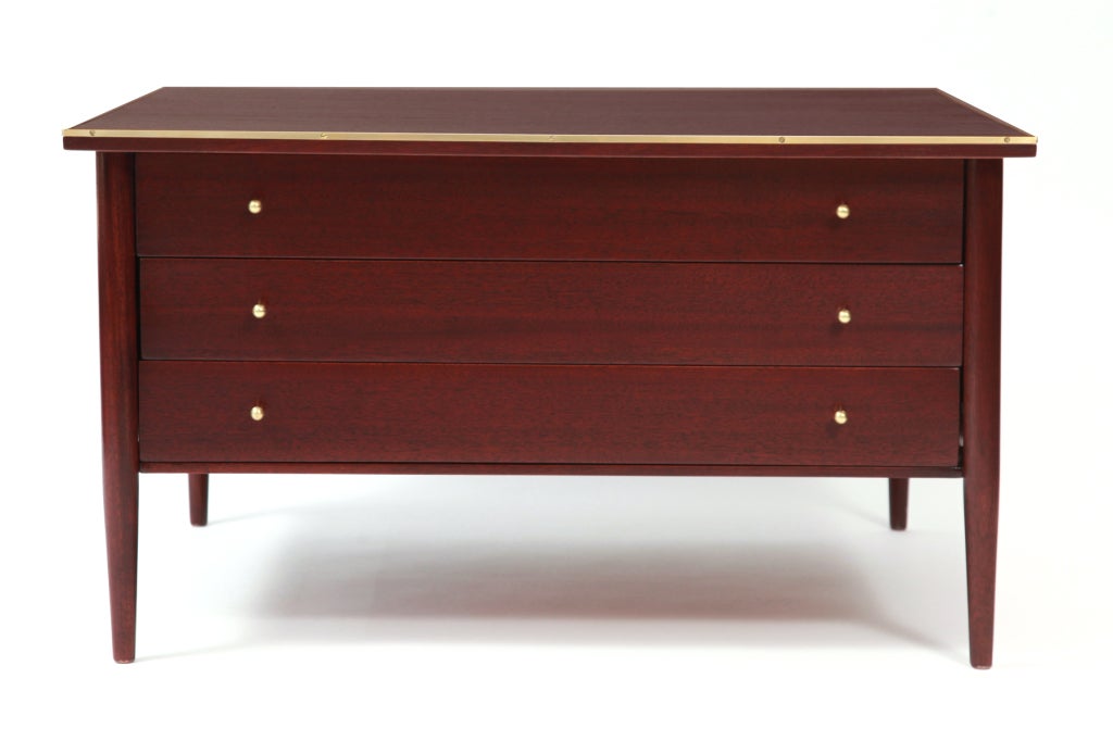 Paul Mccobb for Calvin small chest of drawers, circa late 1950s. This striped African mahogany example has three drawers with brass ball pulls, brass trim and has recently been finished. Retains original Calvin decal.