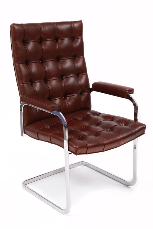Eight cantilevered chrome and leather dining chairs by Stendig, circa early 1970s. These examples have sculptural chrome frames and have recently been upholstered in fantastic button tufted chocolate brown leather. Arm height 25