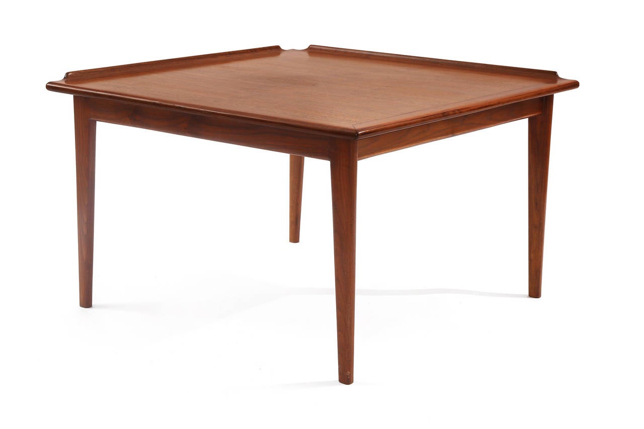 Finn Juhl for Baker furniture oiled teak occasional or side table, circa mid-1960s. This all original example has linear subtly tapered legs elevated sides to the top and beautiful graining. Some slight wear to the center of the table.