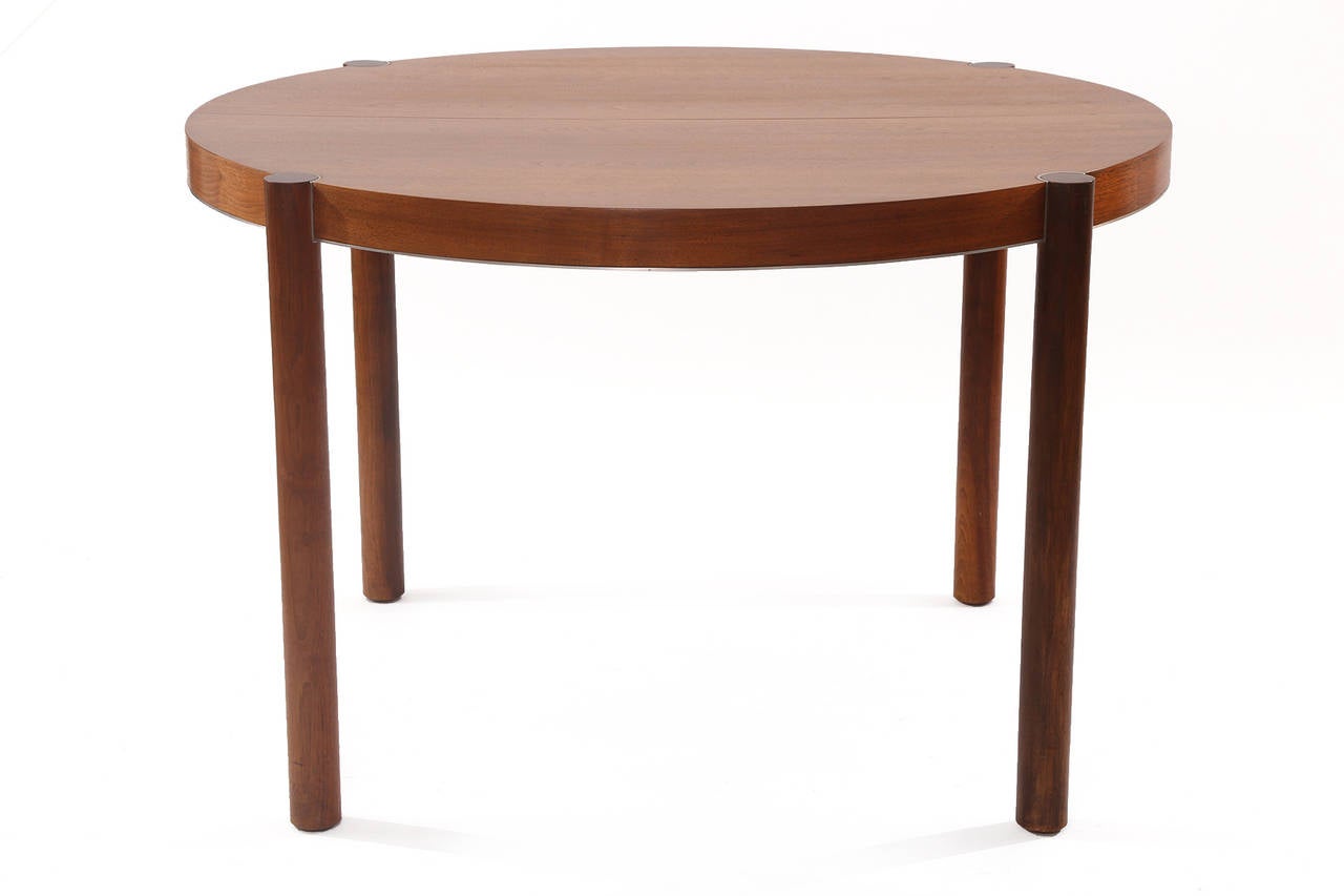 John Kapel for Glenn of California walnut and steel dining table, circa late 1960s. This stunning all original example has conical solid walnut legs with inset steel around the tops and sides. The top is beautifully grained walnut and the table has