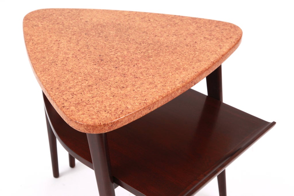 Sculptural solid mahogany and cork occasional table by Paul Frankl for Johnson furniture, circa late 1940s. This example has a solid cork triangular top a second tier that is solid mahogany and two flared solid mahogany back legs. Please see our