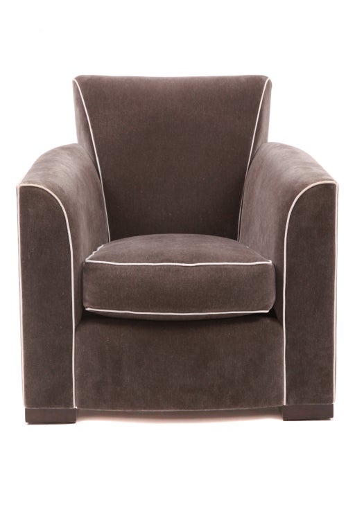 Lovely Mohair lounge chair and ottoman by Donghia. This example is upholstered in a stunning charcoal gray mohair with light gray piping. The chair and ottoman are in excellent original condition. Price is for the chair and ottoman.
Arm height is