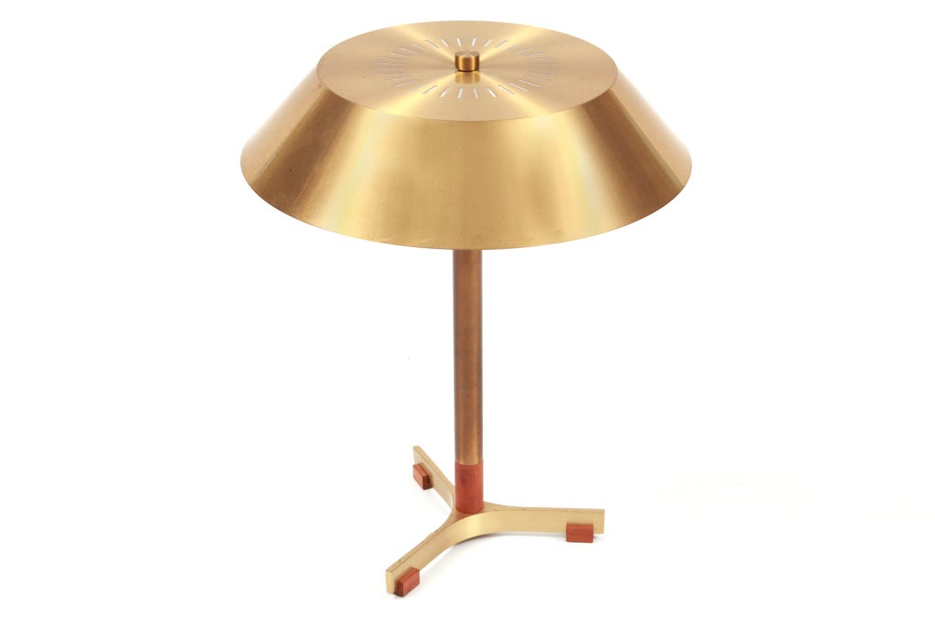 Gorgeous brass and teak table lamp by Fog and Mørup, circa early 1960s. This example has a patinated brass stem and shade with solid teak accents.
