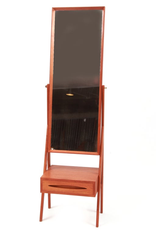 Arne Vodder teak mirror with storage, circa mid-1960s. This all original example has Vodder's trademark oval drawer pull, one dove tailed drawer, adjustable teak framed rectangular mirror and sculptural solid teak legs.