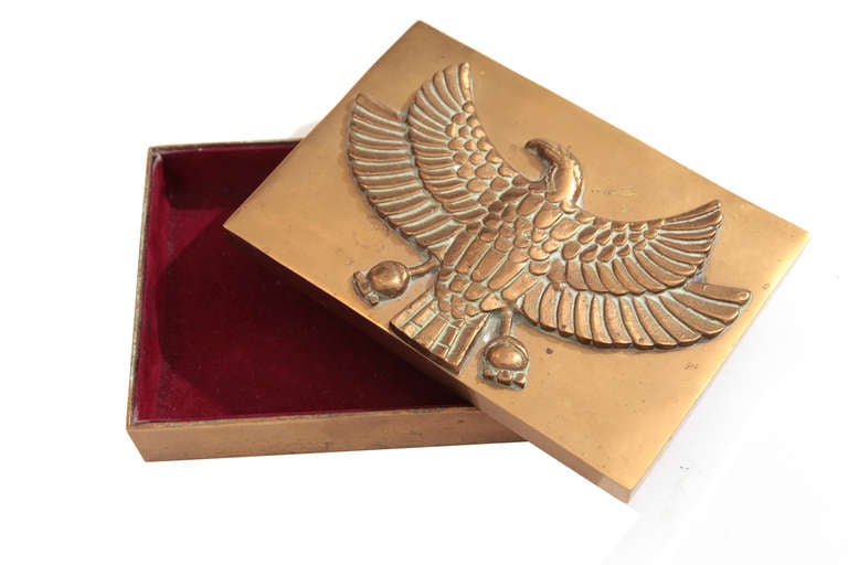 Solid brass jewelry box with eagle motif circa early 1950's. This example has an elegant and detailed bird on the lid and is lined in velvet.