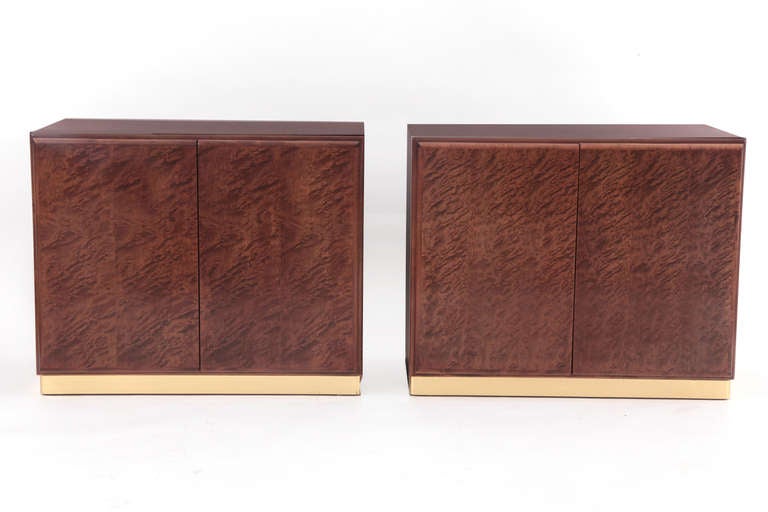 Fantastic Milo Baughman for Thayer Coggin burl wood nightstands, circa early 1970s. We have two variations of these. This example has two doors that open to reveal an adjustable open shelf. The bases are a satin brass plinth.