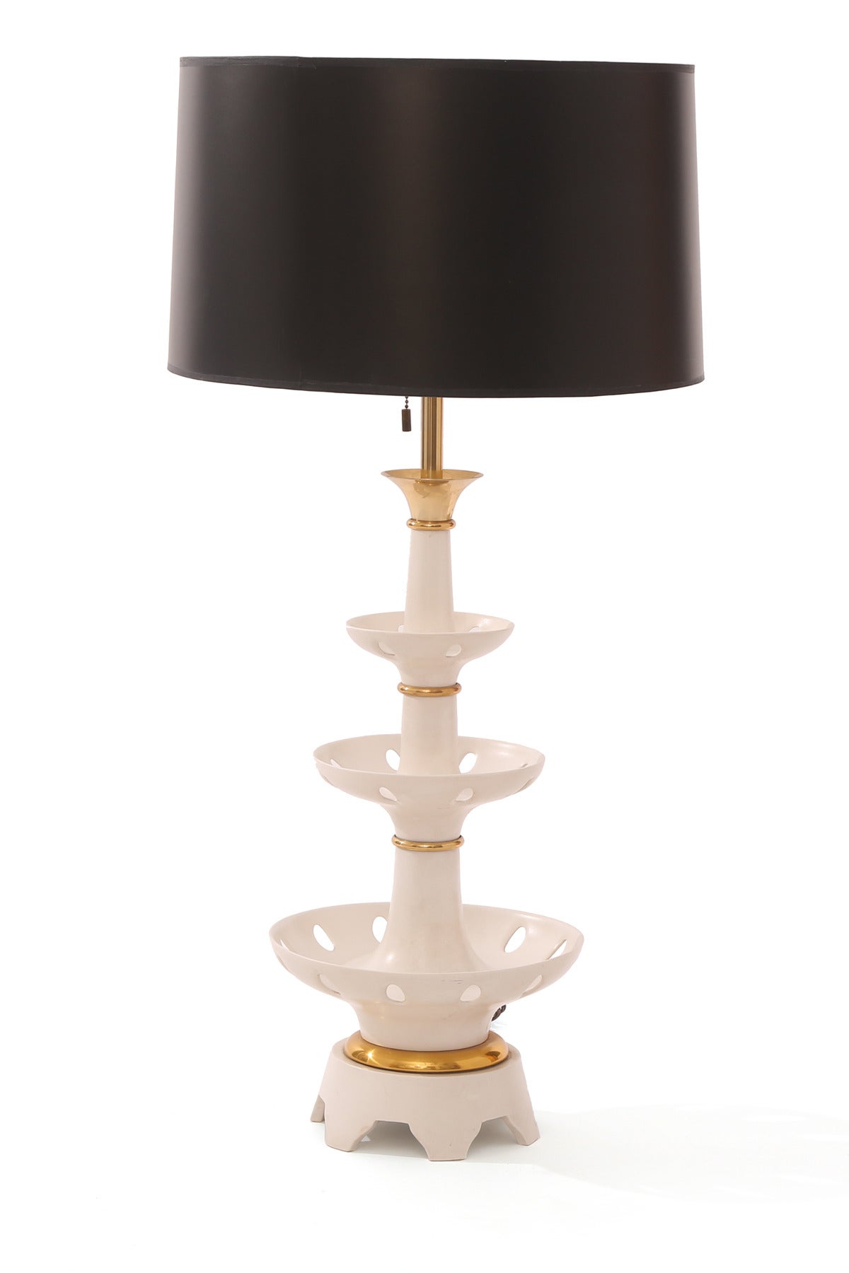 Large-scale pair of architectural table lamps by Gerald Thurston for Lightolier, circa mid-1950s. These fabulous examples have three ceramic tiers with circular cutouts and brass stems and accents. Measures: Height to top of socket is 30.5