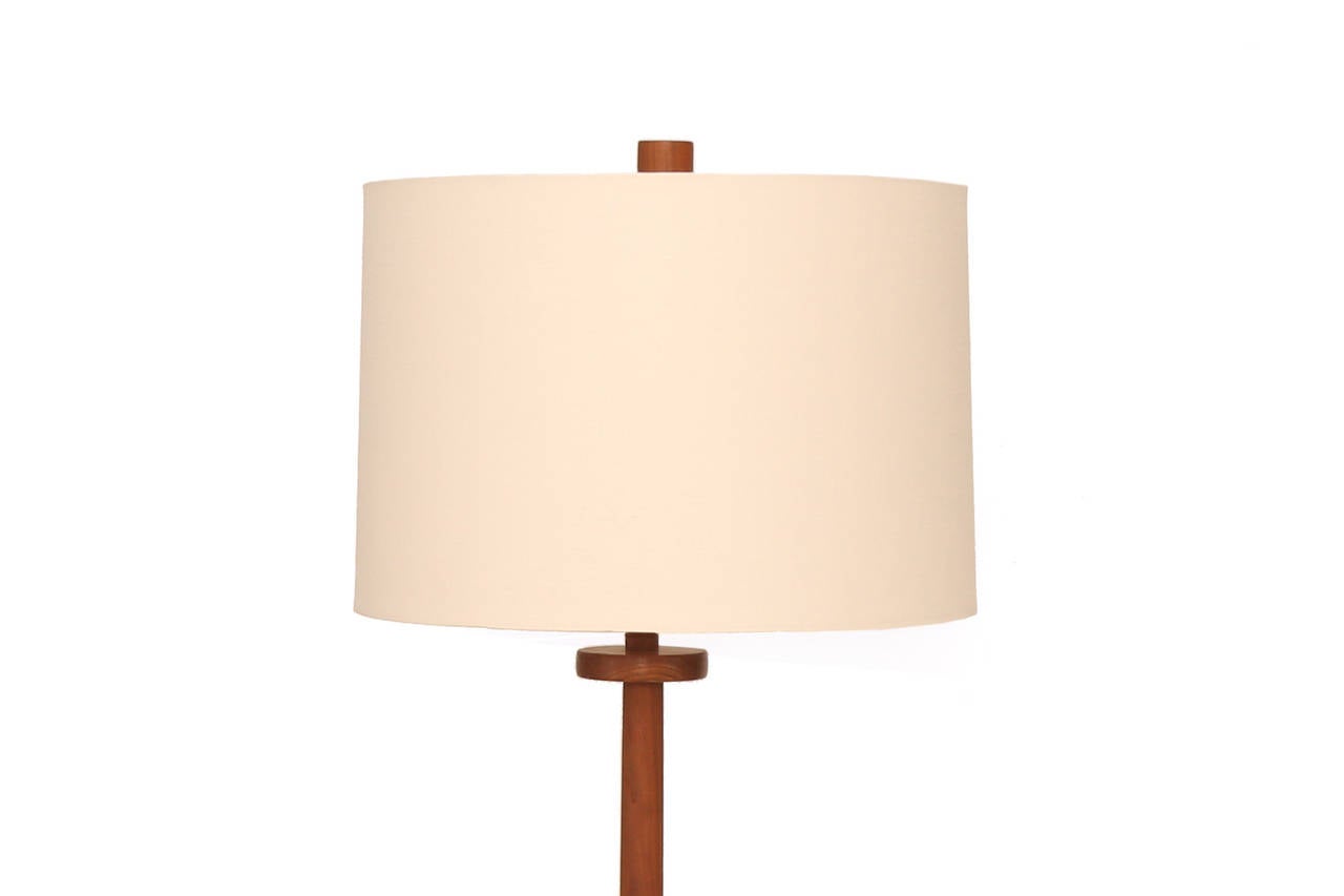 Elegant teak and ceramic floor lamp by Jane and Gordon Martz, circa late 1950s. This example made for Marshall Studios has inset gray and blue circular tiles in the base and retains its solid teak finial. Sold without the shade.
Height measurement