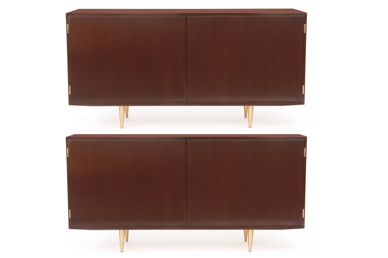 Pair of mahogany and brass chests from Denmark, circa late 1950s. These lovely examples each have beautifully grained mahogany cases with brass hinges and tapered brass legs. The interiors are maple with adjustable shelves and interior drawers.