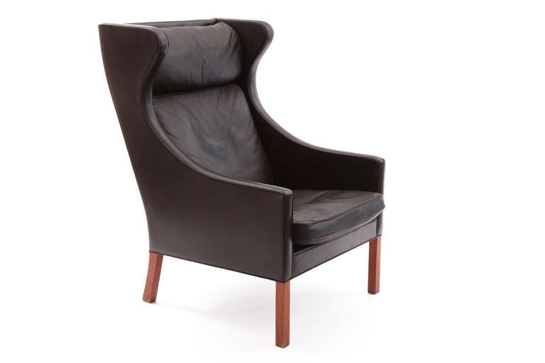 Early Borge Mogensen for Fredericia leather wing back chair. This all original example has solid teak legs and is upholstered in a stunning dark chocolate brown leather.
