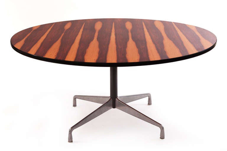 Charles and Ray Eames for Herman Miller rosewood dining table circa mid 1960's. This incredible example has some of the best rosewood we have ever seen. Big blonde sap grain and beautifully grained rosewood over the iconic Herman Miller base. Rare