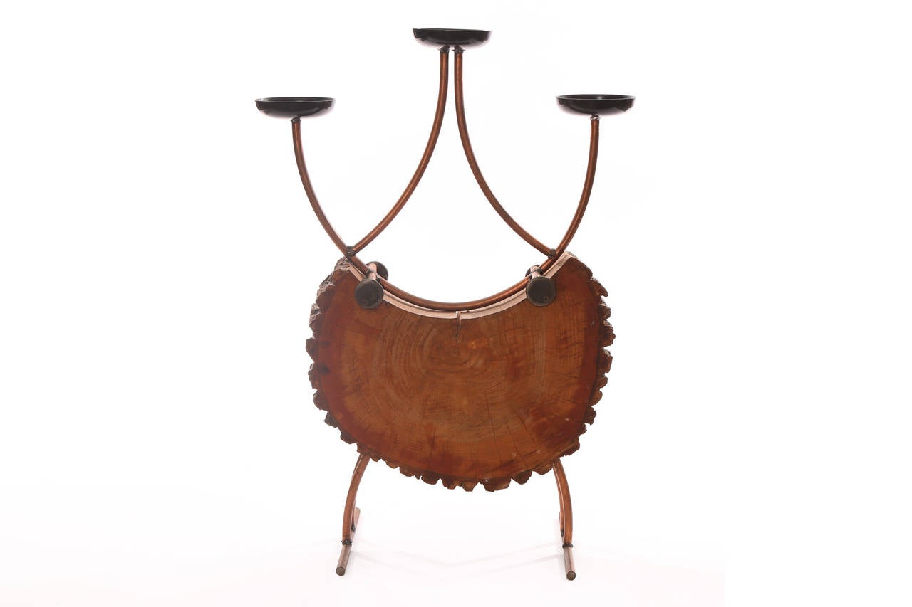 Rustic wood and copper candelabra or candleholder, circa late 1950s. This example unusually melds carved wood and patinated copper.