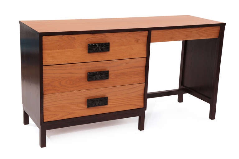 Very rare Dunbar desk for the Arizona Biltmore, circa mid-1960s. There were only a handful of these desks ever made. It has two-toned beautifully grained ashwood and tapered drawer fronts. The pulls have the iconic Frank Lloyd Wright motif. It has