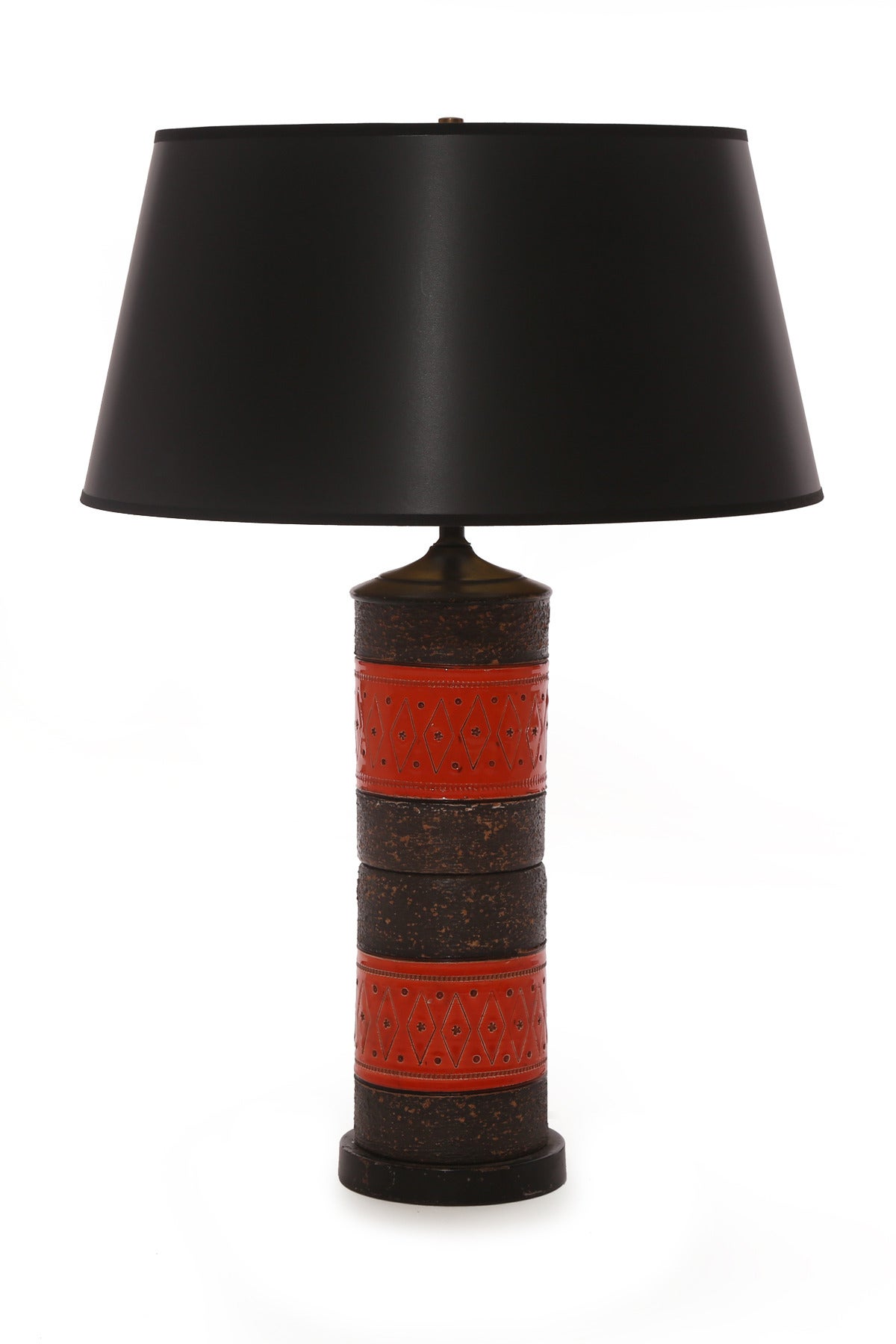 Fabulous pair of ceramic and enameled metal table lamps from Italy, circa early 1960s. These wonderful examples have earth tone ceramic bodies with volcanic glazing with persimmon enameled metal accents. Price listed is for the pair with shades.