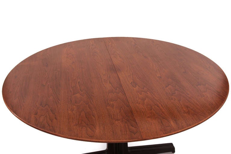 Sculptural Edward Wormley for Dunbar walnut dining table circa late 1950s. This example has a beautifully grained walnut top and stunning solid walnut base. This table can accommodate two leaves but currently does not have any. We are happy to make