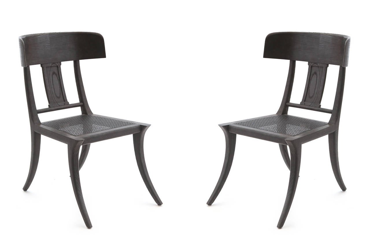 Pair of Cerused Oak 'Klismos' chairs by Michael Taylor. These stunning examples are done in a charcoal gray lacquer over solid oak frames with lovely graining. The cane seats are lacquered the same charcoal gray and can accommodate an upholstered