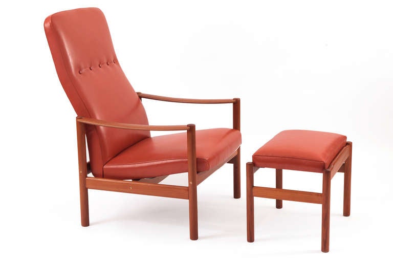 Solid teak and leather lounge chair circa early 1960's. This sculptural example has a newly finished solid teak frame and has been newly upholstered in a lovely pumpkin orange leather.  Price listed is for both the chair and ottoman. Ottoman