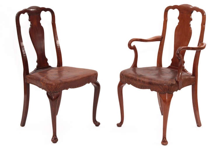Set of six hand carved burled walnut queen Anne dining chairs circa early 20th century. These examples are upholstered in their original perfectly broken in leather with bronze nail head detailing. The burled walnut frames are subtly curved with