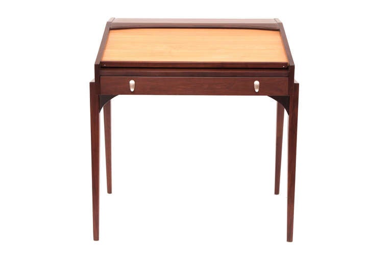 John Van Koert for Drexel walnut and birch desk, circa late 1950s. This stunning example has a sculptural solid walnut frame with inset birch tambour door. There is one large drawer and interior cubbies and storage space behind the tambour door. The