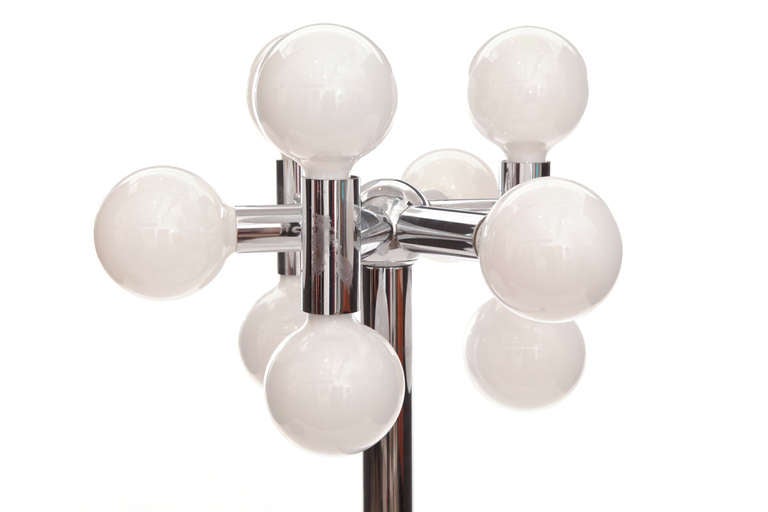 Robert Haussmann chrome and glass floor lamp, circa late 1960s. This example mixes tubular chrome-plated steel rods with snow white glass bulbs and enameled metal base.