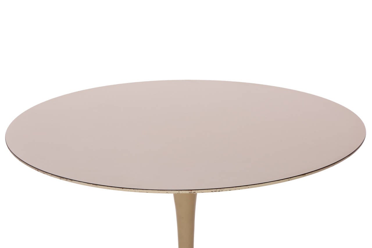 Iron base tulip table by Eero Saarinen for Knoll, circa early 1960s. This all original example is two-tone with an almond enamel base and off white 36