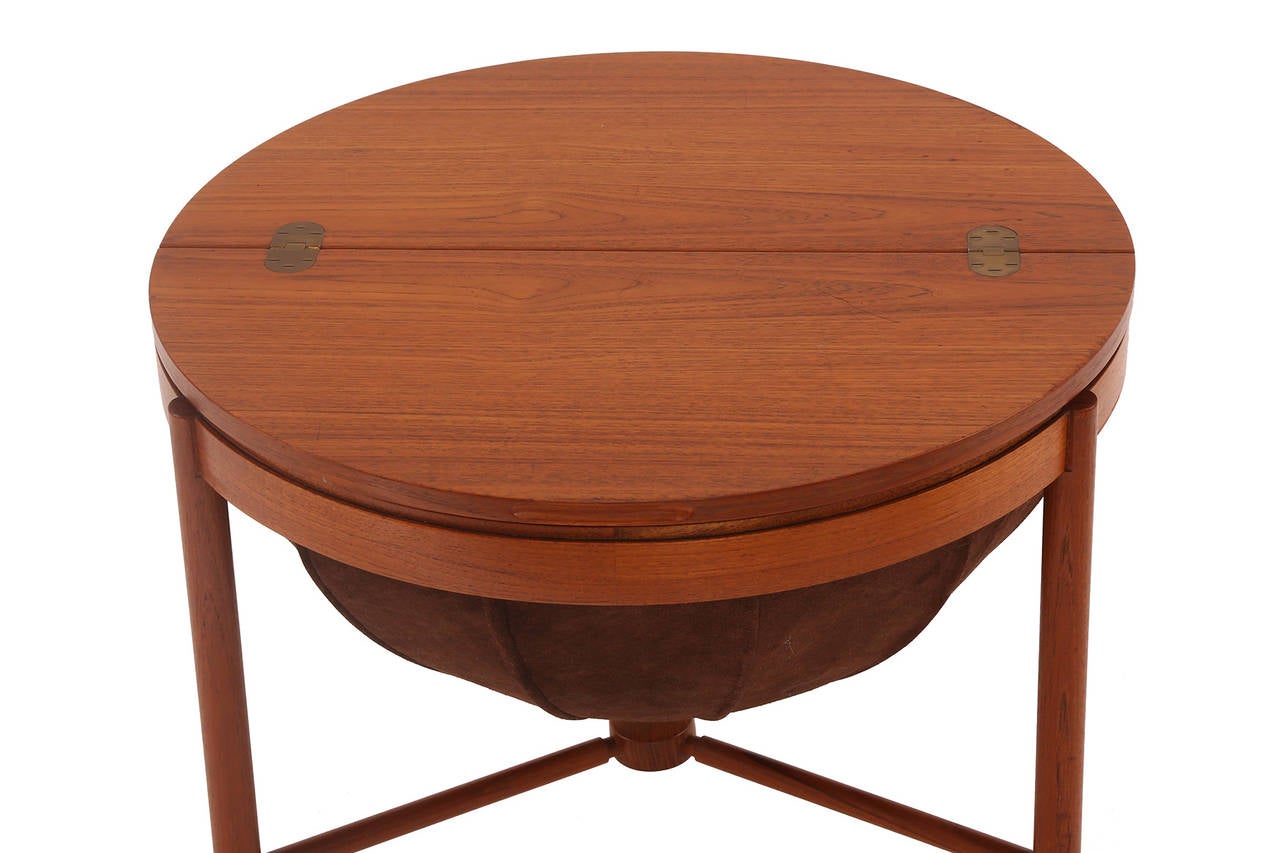 Teak and suede sewing table or chest by Rastad and Relling for Rasmus Solberg, circa early 1960s. This all original example has a solid teak frame and stretchers with a chocolate brown suede basket interior. The interior has a teak drawer with